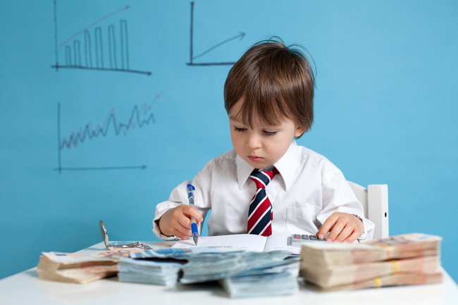 Young boy, counting money and taking notes