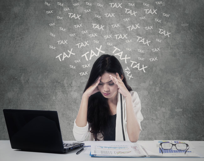 Confused woman counting her tax