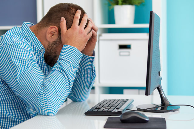 Young business man under stress with headache